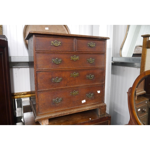 2157 - An early Georgian oak straight front chest of two short over three long graduated drawers, on bracke... 