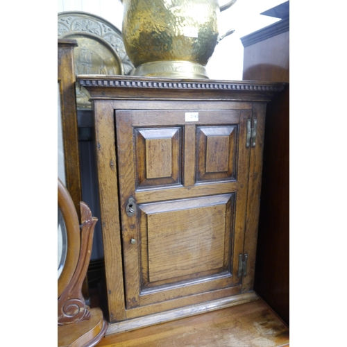 2162 - An 18th Century stripped panelled oak wall cupboard