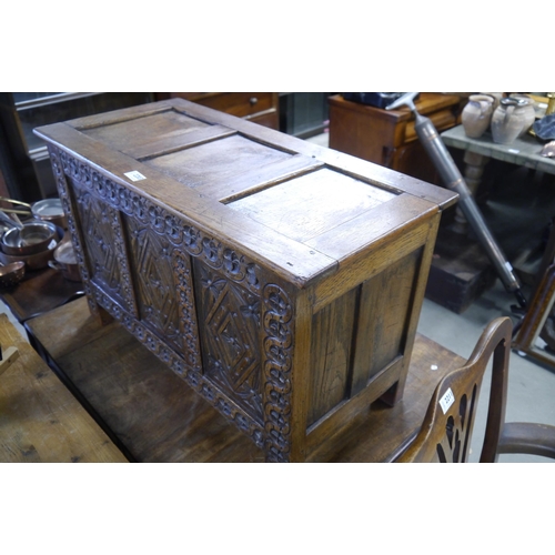 2203 - A heavily carved oak diminutive coffer, 47cm Tall x 76cm Width x 36cm Deep