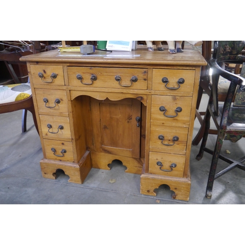 2209 - A Georgian style pine knee hole ladies desk with 9 drawers and central cupboard