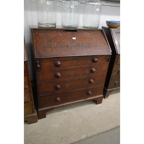 2224 - A Georgian oak four drawer bureau, slope a/f