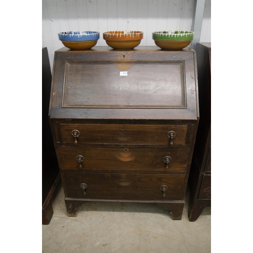 2233 - A 1930's oak three drawer bureau