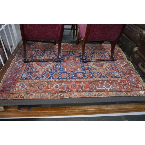 2245 - A Persian red, blue and green rug.  103cm x 140cm