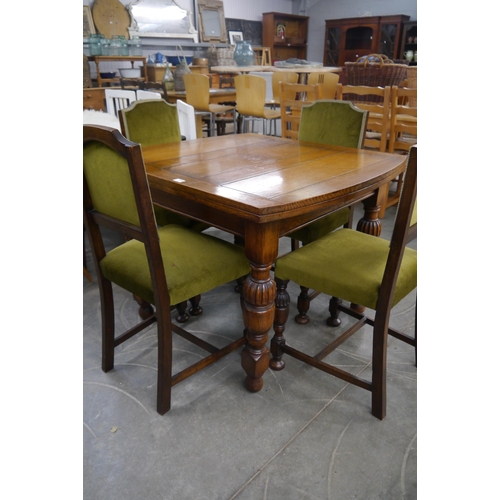 2248 - A 1940's oak dining table and four chairs