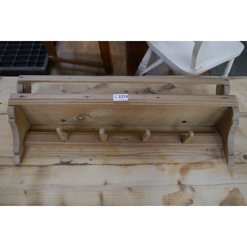 2274 - A 19th Century country pine and wall rack with peg hooks 2ft long