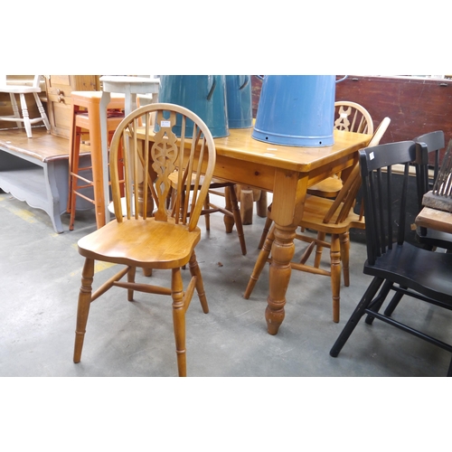 2291 - A modern pine kitchen table together with a set of four beech wheel-back kitchen chairs (5)