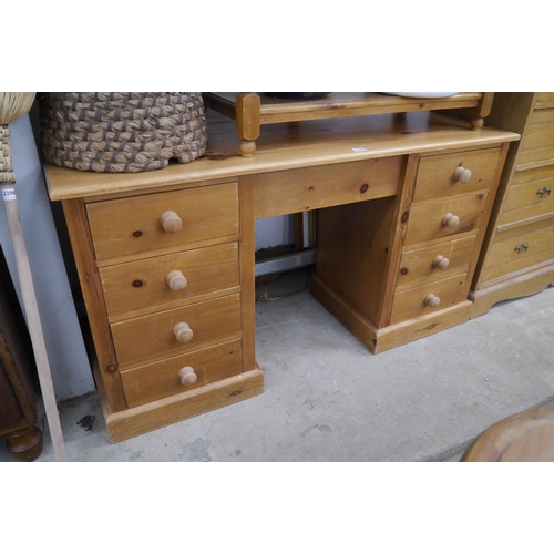 2300 - A pine pedestal desk with eight drawers