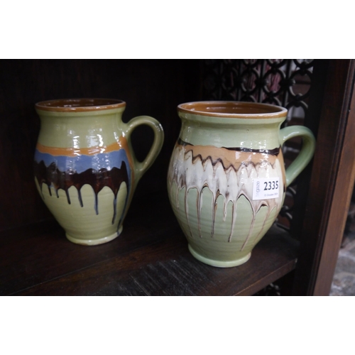 2335 - A pair of green drip-glazed pots