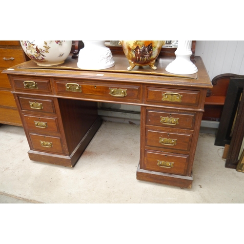 2418 - An Edwardian walnut twin pedestal desk, nine drawer front, plinth base