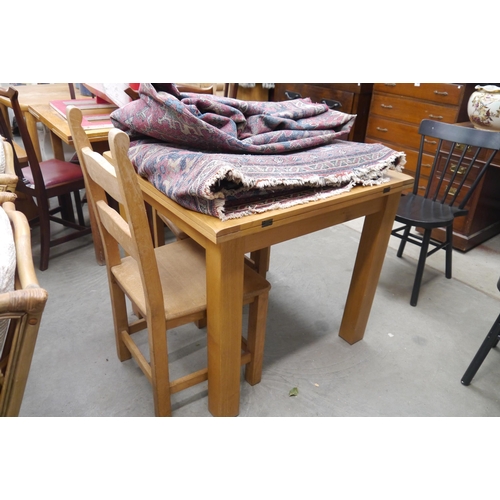 2435 - An oak kitchen table and two oak chairs and two black chairs