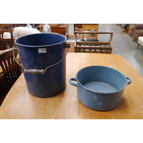 2440 - A blue enamel bucket, worm to handle and a twin handled cooking pot