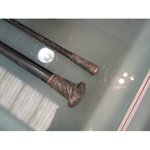 1481 - An Irish shillelagh together with a swagger stick with dragon design white metal knop and a walking ... 