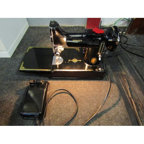 1279 - A Singer Featherweight sewing machine, cased with accessories