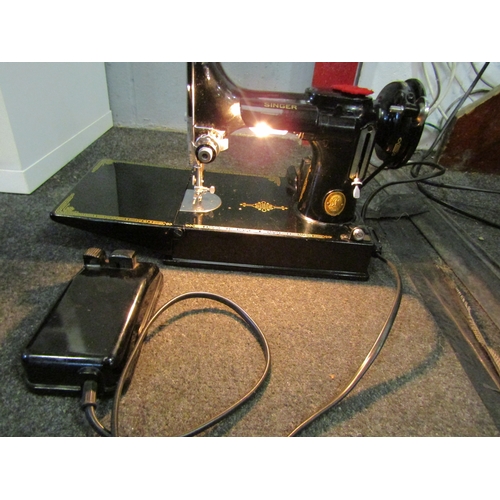 1279 - A Singer Featherweight sewing machine, cased with accessories