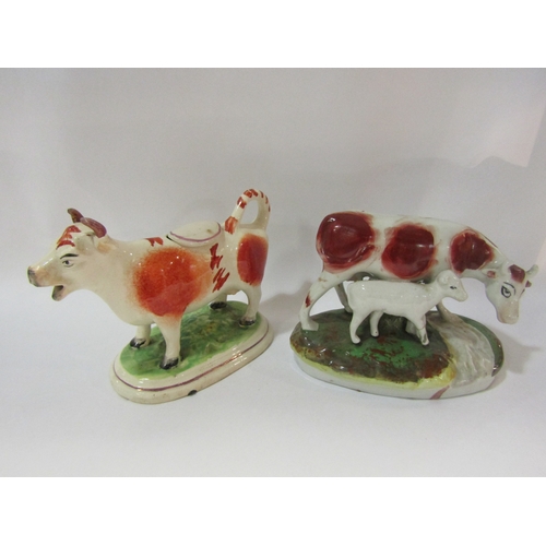 4261 - Two early Staffordshire cows, a creamer and a cow and calf figural group (calf leg a/f)