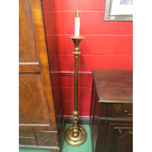 4076 - A carved and reeded gilt standard lamp on a circular base