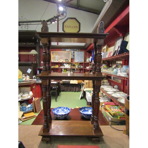 4090 - A late Victorian walnut three tier open bookshelf of small proportions with carved decoration over r... 