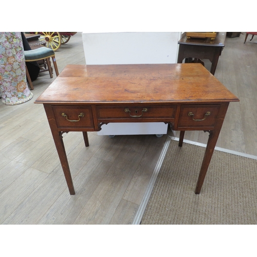 4104 - A George III North Country oak low boy with mahogany crossbanding the three frieze drawers with bras... 