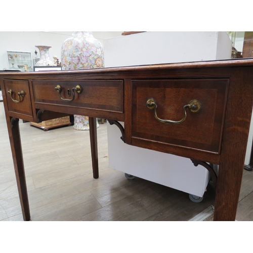 4104 - A George III North Country oak low boy with mahogany crossbanding the three frieze drawers with bras... 