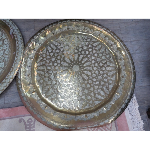 4147 - Two Iranian large brass chargers, all over etched decoration, 90cm diameter