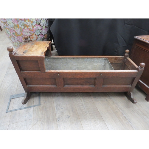 4169 - A George III panelled oak rocking crib, with hood, 58cm tall x 107cm long x 49cm wide