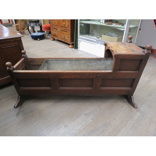 4169 - A George III panelled oak rocking crib, with hood, 58cm tall x 107cm long x 49cm wide