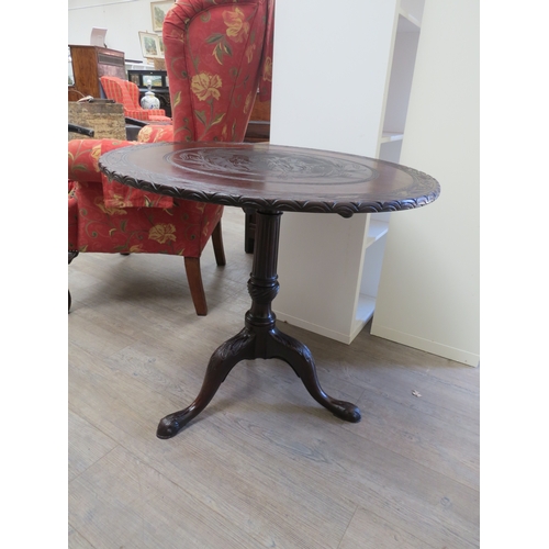 4191 - A George III Cuban mahogany circular tilt-top wine table with later carved decoration having three m... 