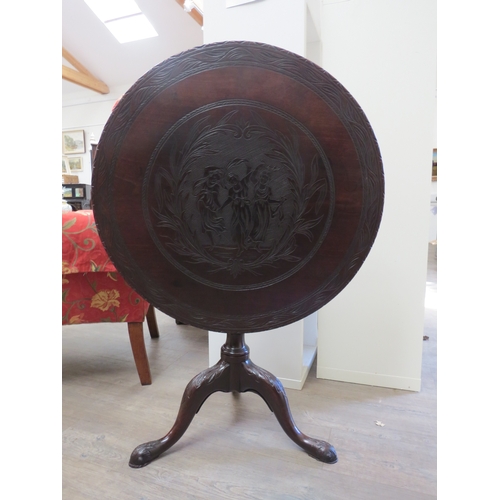 4191 - A George III Cuban mahogany circular tilt-top wine table with later carved decoration having three m... 