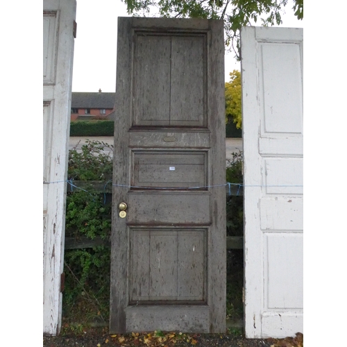 8004 - An oak three panel door, 242cm x 85cm