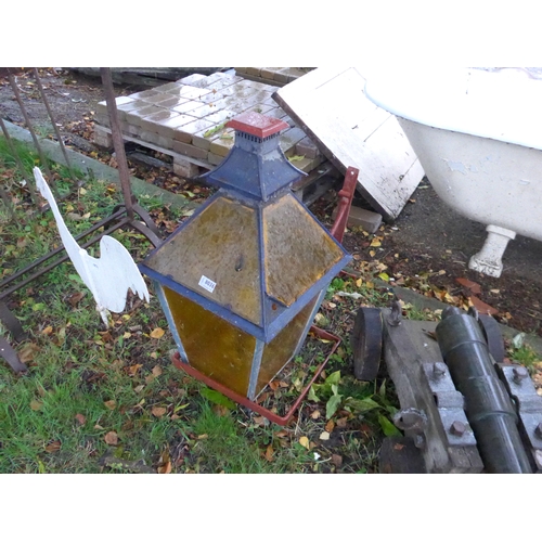 8036 - A vintage amber glass street lantern with cast metal wall bracket, 71cm tall