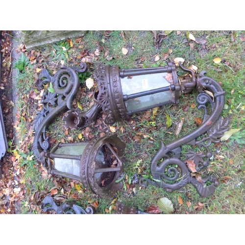 8044 - A pair of decorative cast iron lanterns with brackets