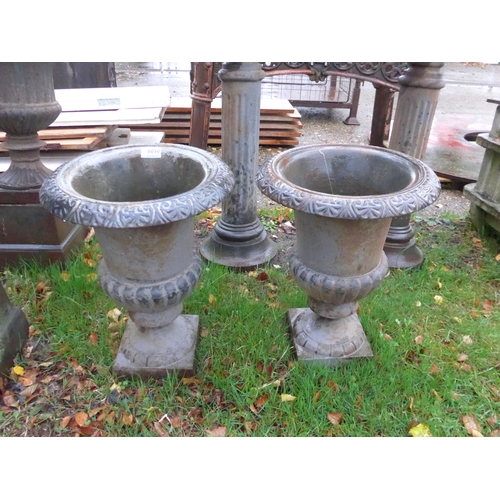 8050 - A pair of cast iron urns, 43cm tall