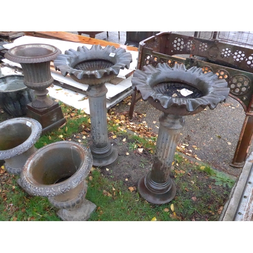 8051 - A pair of cast iron urns on column base, 76cm tall