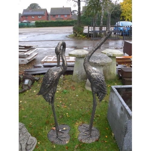 8094 - A pair of bronzed aluminium standing cranes, tallest is 238cm