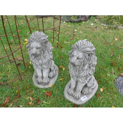 8095 - A pair of seated composition lions, 39cm tall