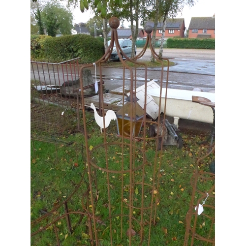 8104 - A pair of steel rust finish ball top obelisks