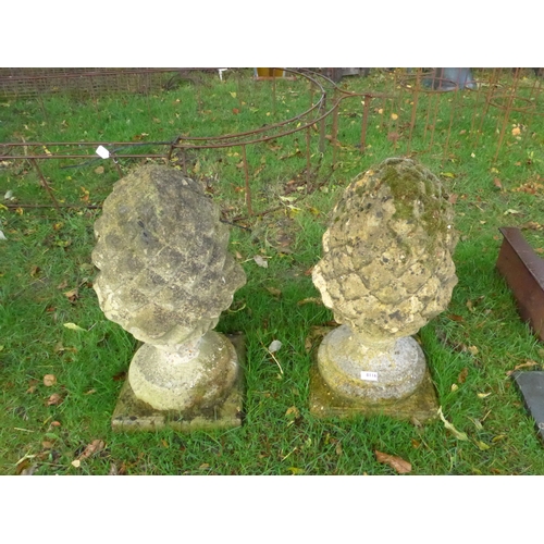 8116 - A pair of weathered acorn finials, approx 63cms tall