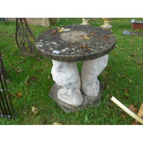 8168 - A round composition garden table on three owl base