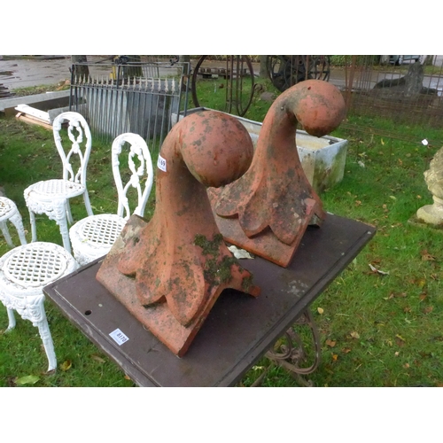 8169 - A pair of scrolled terracotta roof finials