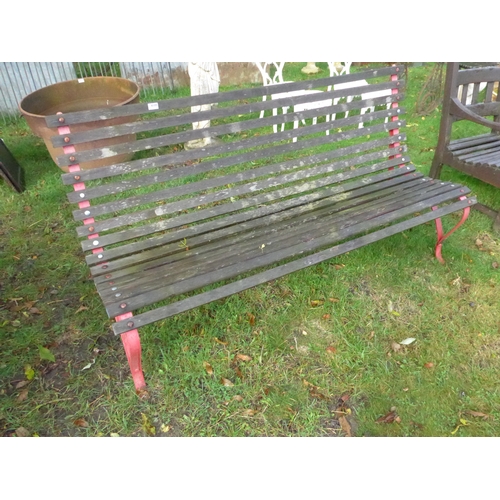 8185 - A wooden slatted, iron ended garden bench