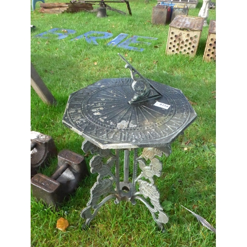 8256 - A cast iron and alloy octagonal sundial on decorative feet, 50cm tall