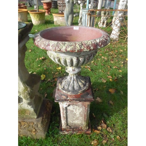 8267 - A terracotta urn on plinth, leaf detail, 90cm tall