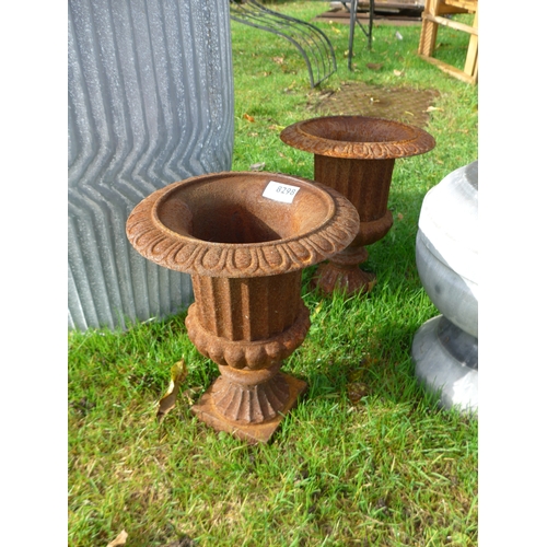 8298 - A pair of cast iron urns, 25cm diameter, 30cm tall