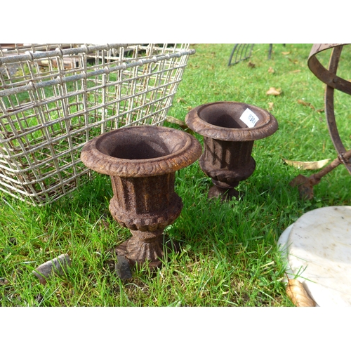 8301 - A pair of cast iron urns, 15cm diameter