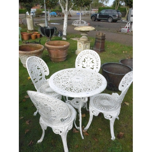 8394 - A cast alloy decorative garden table and four chairs