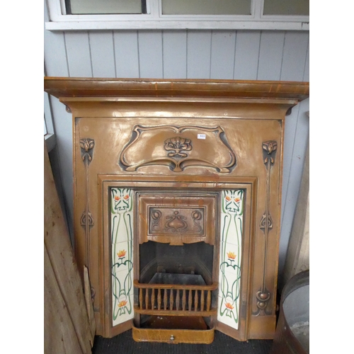 8439 - An Art Nouveau cast fire place with tiled jambs and foliate detail