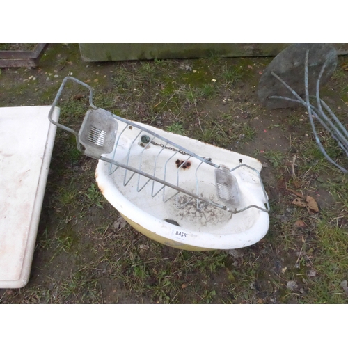 8458 - A cast iron enamelled basin and brass bath rack