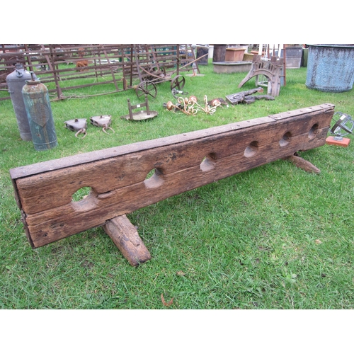 8465 - A set of 17th Century oak and iron three person set of leg stocks