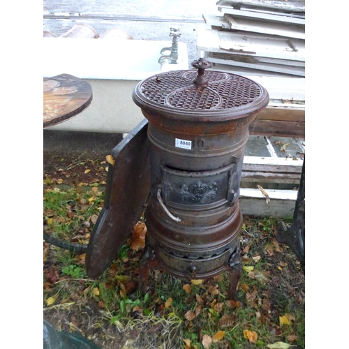 8040 - A No.10 cast iron Tortoise stove with associated cast metal base plate