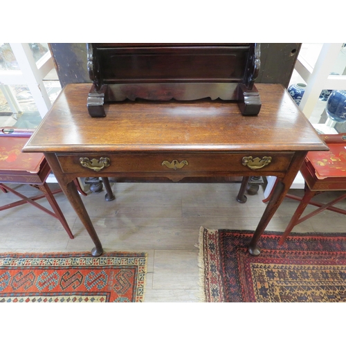 4171 - An early George III oak side table, with long frieze drawer and tapering cylindrical legs to pad fee... 